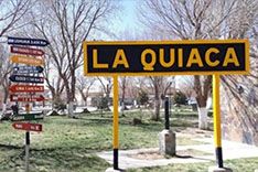 Sign of La Quiaca with trees in the background